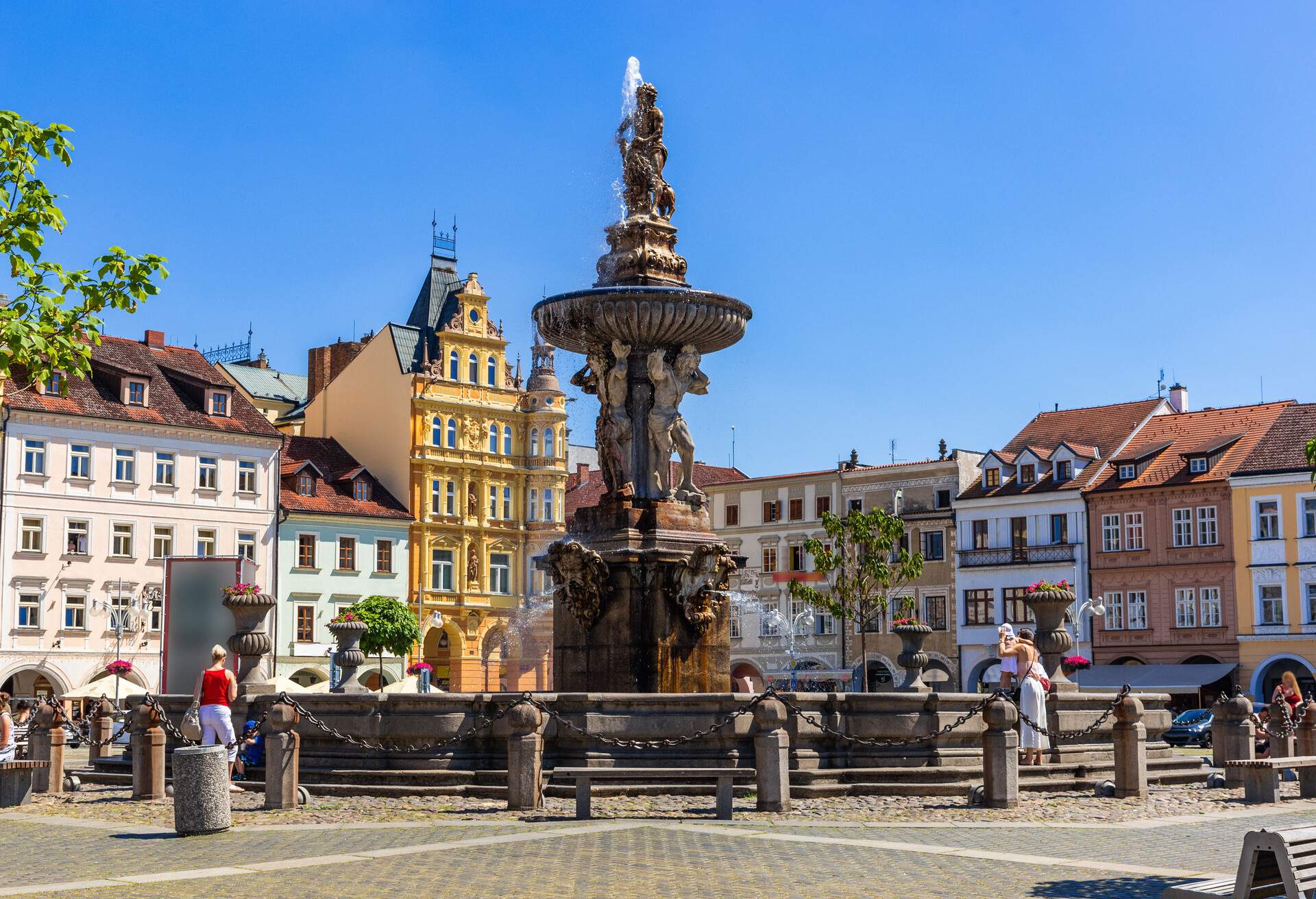 Main square with Samson fighting the lion fountain sculpture and bell tower in Ceske Budejovice. Czech Republic.